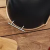 A close-up view of a black bread bin with silver handles, resting on a wooden surface. Produktbild-Vorschau