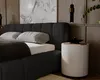 A modern bedroom scene featuring a bed, nightstand, and wall art. Náhled obrázku produktu