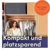 A woman is standing in front of an open closet with clothes hanging on a rack. There is text overlaying the bottom of the image and a circular logo in the top right corner. Produktbild-Vorschau