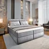 A modern bedroom with a large bed, bedside tables, and a chair. Produktbild-Vorschau