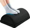 A pair of feet wearing gray socks rests on a black footrest. Produktbild-Vorschau