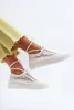 A person's legs wearing white lace sneakers with ankle straps. Voir les images du produit