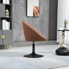 A brown fabric armchair with a black base is placed in a modern living room setting. Produktbild-Vorschau