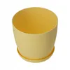 A yellow plant pot with a saucer on a white background. Náhled obrázku produktu