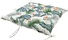 A square cushion with a tropical leaf pattern, shown from a slightly elevated angle against a white background. Produktbild-Vorschau