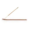 A single incense stick resting on a wooden incense holder, isolated on a white background. Produktbild-Vorschau