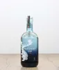 A bottle of Harahorn Gin is placed on a wooden surface against a white background. Produktbild-Vorschau
