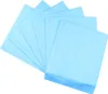 A stack of light blue disposable dog pee pads fanned out against a white background. Náhled obrázku produktu