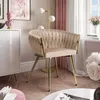 A stylish beige upholstered chair with gold legs in a well-decorated room. Náhled obrázku produktu