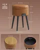 A collage of images showing a brown faux leather storage ottoman with black metal legs, including dimensions and close-ups of the top and interior. Náhled obrázku produktu