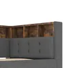 A close-up view of a gray upholstered bed frame with a built-in wooden bookshelf headboard. Produktbild-Vorschau
