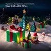 A festive Christmas scene with decorated trees, gifts, and figurines in the snow. Produktbild-Vorschau