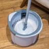 A mop and bucket set on a wooden floor. Podgląd zdjęcia produktu