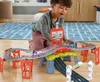 A young boy plays with a toy train set on the floor. Náhľad obrázku produktu