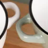 Close-up of two enamel bowls with handles. Produktbild-Vorschau