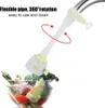 A faucet extender is shown attached to a faucet, with water spraying into a bowl of vegetables. Produktbild-Vorschau