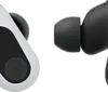 Close-up of two wireless earbuds, one white and one black, against a white background. Produktbild-Vorschau
