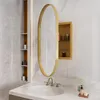 A bathroom vanity with a sink, faucet, and an oval mirror with a medicine cabinet behind it. Voir les images du produit