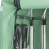 Close-up view of garden tools hanging inside a green storage unit. Produktbild-Vorschau