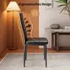 A black faux leather dining chair with an ergonomic design, shown in a room with a floor lamp and a side table. Náhled obrázku produktu