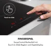 A hand is shown interacting with a touch-sensitive control panel on a black induction cooktop. Produktbild-Vorschau