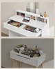 A vanity table with makeup and accessories is shown in two different lighting conditions. Náhled obrázku produktu