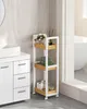 A white and wood-colored rolling storage cart in a bathroom next to a vanity. Náhled obrázku produktu