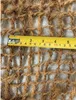 A close-up of a coconut fiber mat with a measuring tape laid across it. Produktbild-Vorschau