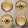 Four brass door knobs are arranged in a two-by-two grid against a light gray background. Produktbild-Vorschau