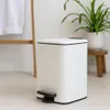 A white pedal bin is shown in a bathroom setting. Náhled obrázku produktu