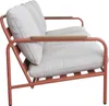A side view of a three-seater outdoor sofa with a terracotta-colored metal frame and beige cushions. Podgląd zdjęcia produktu