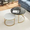 A set of two nesting coffee tables with marble-look tops and gold metal frames, placed on a rug in a living room setting. Produktbild-Vorschau
