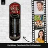 A collage showing a thermometer with grilling-themed graphics, a man laughing, a grill with food, and a woman pointing. The text indicates it's a grilling gift. Produktbild-Vorschau