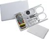 A white sewing kit in a credit card-sized case, with the contents laid out. Produktbild-Vorschau