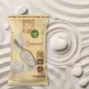 A bag of Dr.Soil Quartzsand is placed on a surface of sand with raked patterns and several smooth white stones. Podgląd zdjęcia produktu