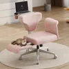 A pink office chair with a laptop tray and a cat resting on the footrest, in a home office setting. Podgląd zdjęcia produktu