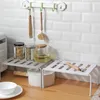 Kitchen counter with storage shelves, jars, and kitchen utensils. Podgląd zdjęcia produktu