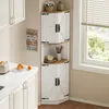 A white corner cabinet with wood accents is shown in a kitchen setting next to a window. Podgląd zdjęcia produktu