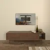 A TV wall mount is shown installed on a wall above a wooden media console in a living room setting. Podgląd zdjęcia produktu