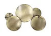 A wall decoration made of several circular metal plates with a gold/bronze finish, arranged in a cluster. Podgląd zdjęcia produktu