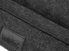 A close-up view of a dark gray fabric with a black trim and a black label with a dog logo and text. Náhľad obrázku produktu