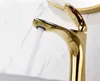A close-up shot of a gold-colored faucet with water running. Produktbild-Vorschau