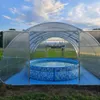 A round inflatable pool inside a greenhouse structure, with a city skyline visible in the distance. Produktbild-Vorschau