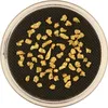 A collection of gold nuggets in a circular container. Produktbild-Vorschau