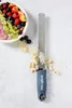 A Microplane zester is shown next to a bowl of fruit and some grated nuts. Náhled obrázku produktu