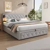 A bedroom scene featuring a large upholstered bed with a tufted headboard, bedside tables with lamps, and a window with a view of greenery. Produktbild-Vorschau