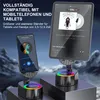 A smartphone and a tablet are displayed on stands with LED lights, showcasing music playback. Produktbild-Vorschau