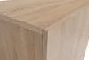 A close-up view of the corner of a wooden cabinet or furniture piece. Náhľad obrázku produktu
