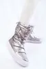 A person wearing silver snow boots. Produktbild-Vorschau