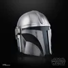 A close-up studio shot of a silver and black Mandalorian helmet against a black background. Voir les images du produit